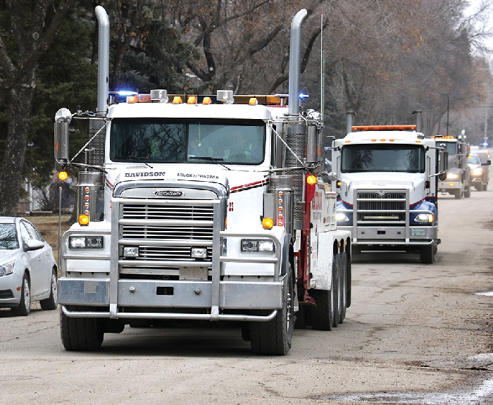 Davidson Truck and Tractor drives by a house with all of their tow trucks and lights flashing during a child’s birthday party last week. They have been doing birthday party drive-bys as a way to make children who are having parties in self isolation feel special.