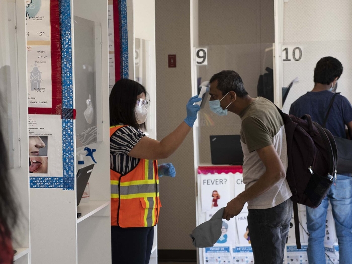 A Maple Leaf Foods employees' temperature is checked upon arriving at work, as is protocol as a result of the COVID-19 pandemic.