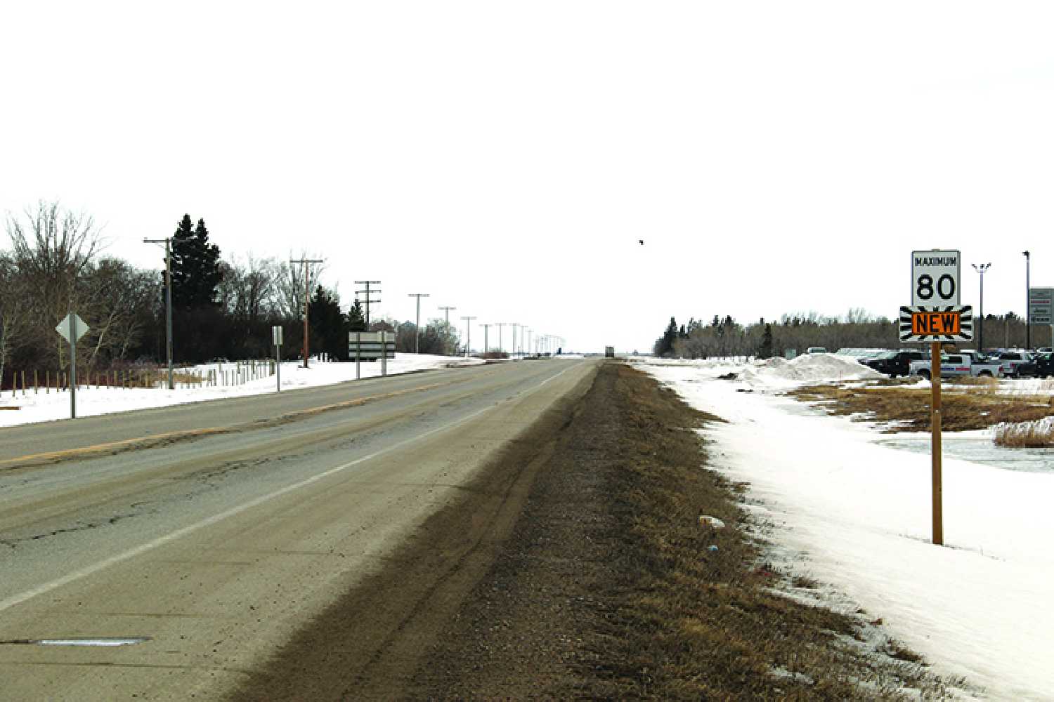 Highway 8 north of Moosomin showing a sign with a reduced speed of 80 km/hr. The speed on the highway was reduced due to safety concerns based on the condition of the road.