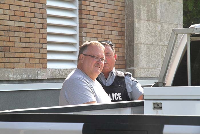 Gregor Gmerek is led out the back door of the Yorkton Court of Queen’s Bench courthouse Tuesday afternoon to be taken to prison. Gmerek was given two four-year penitentiary sentences, for fraud and forgery, to be served concurrently. He was led out of the courtroom in handcuffs following the sentencing.