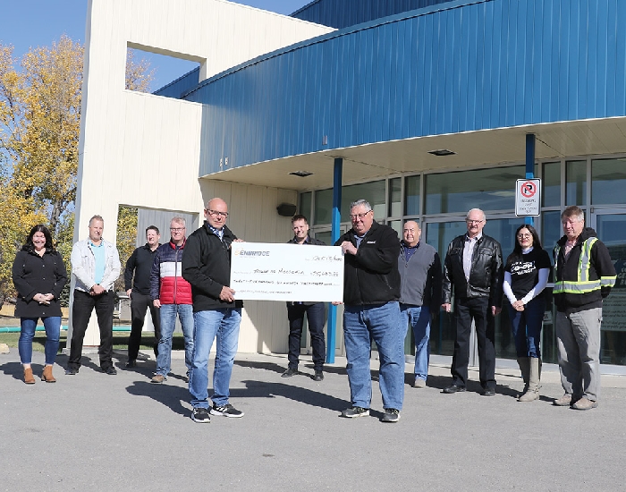 <b>$25,000 contribution</b>Enbridges Al Sawatzky presents a $25,633 cheque to Moosomin Mayor Larry Tomlinson alongside (left to right) Catherine Mannle of the rec department, CAO Paul Listrom, Councillor Murray Gray, Rec Director Mike Schwean, Steve Loney of Enbridge, Councillor Chris Davidson, Councillor Ron Fisk, Tera Harper of Borderland Co-op, and Councillor Garry Towler.