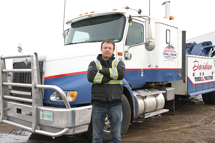 Todd Davidson, the owner of Davidson Truck and Tractor, with his tow truck.