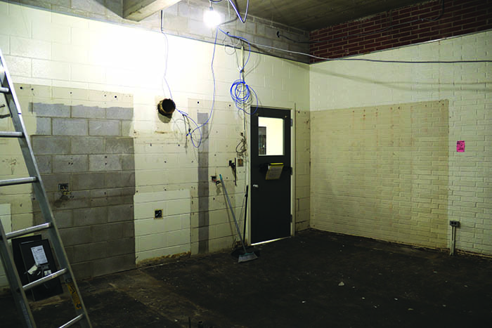The empty kitchen space in Home Ec Lab. At right in the photo, the original brick exterior of the school can be seen.<br />