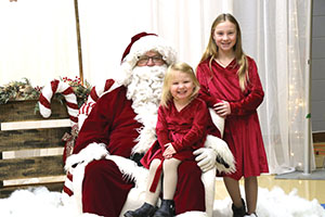 kids posing for photos during Santa Day last year.
