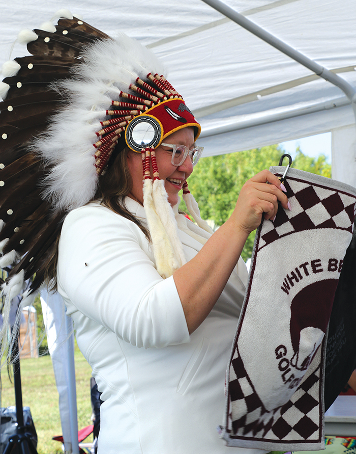 National Chief Cindy Woodhouse Nepinak admiring a welcoming gift from White Bear First Nations.