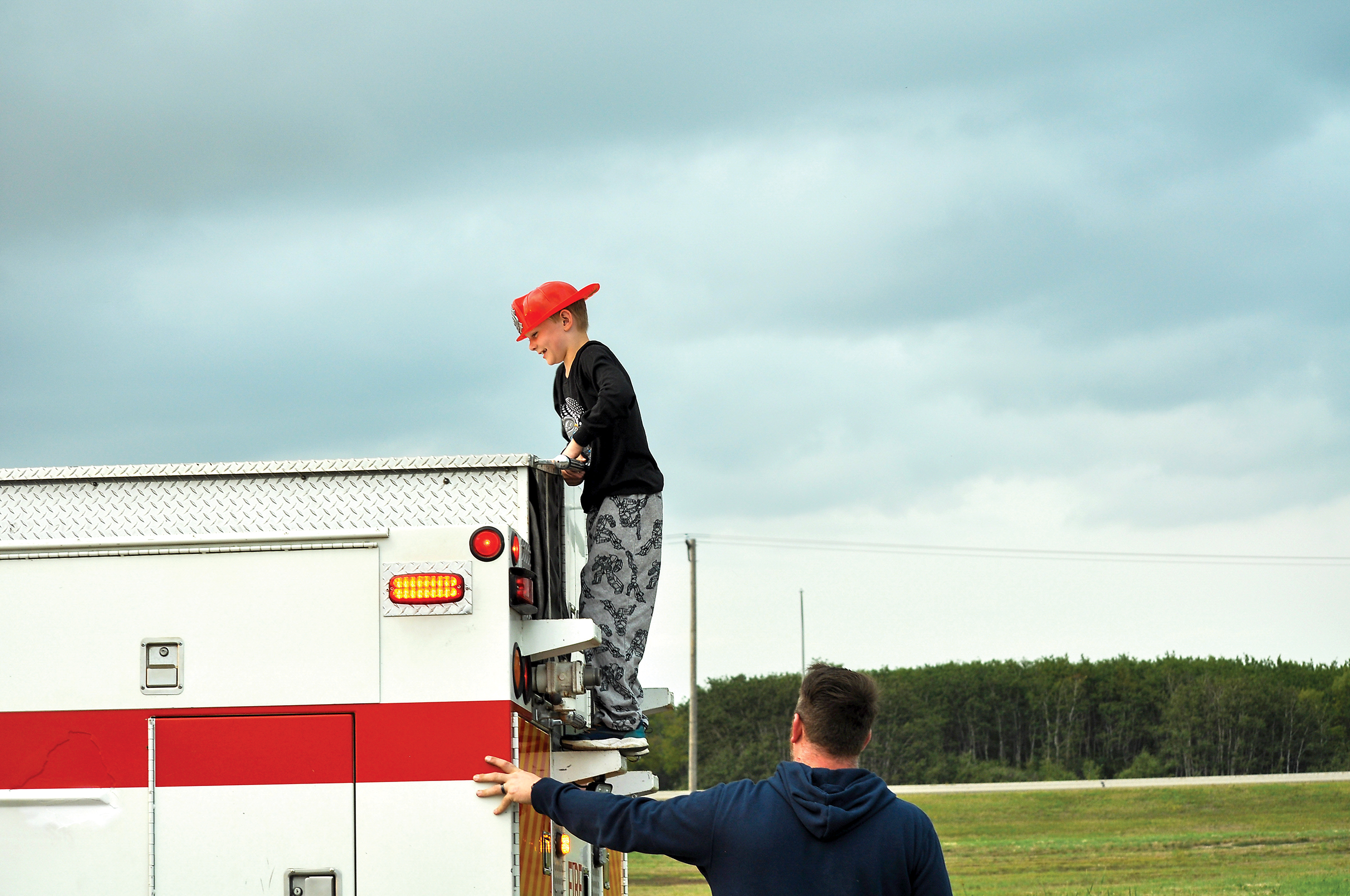 A child checking out one of the fire trucks.