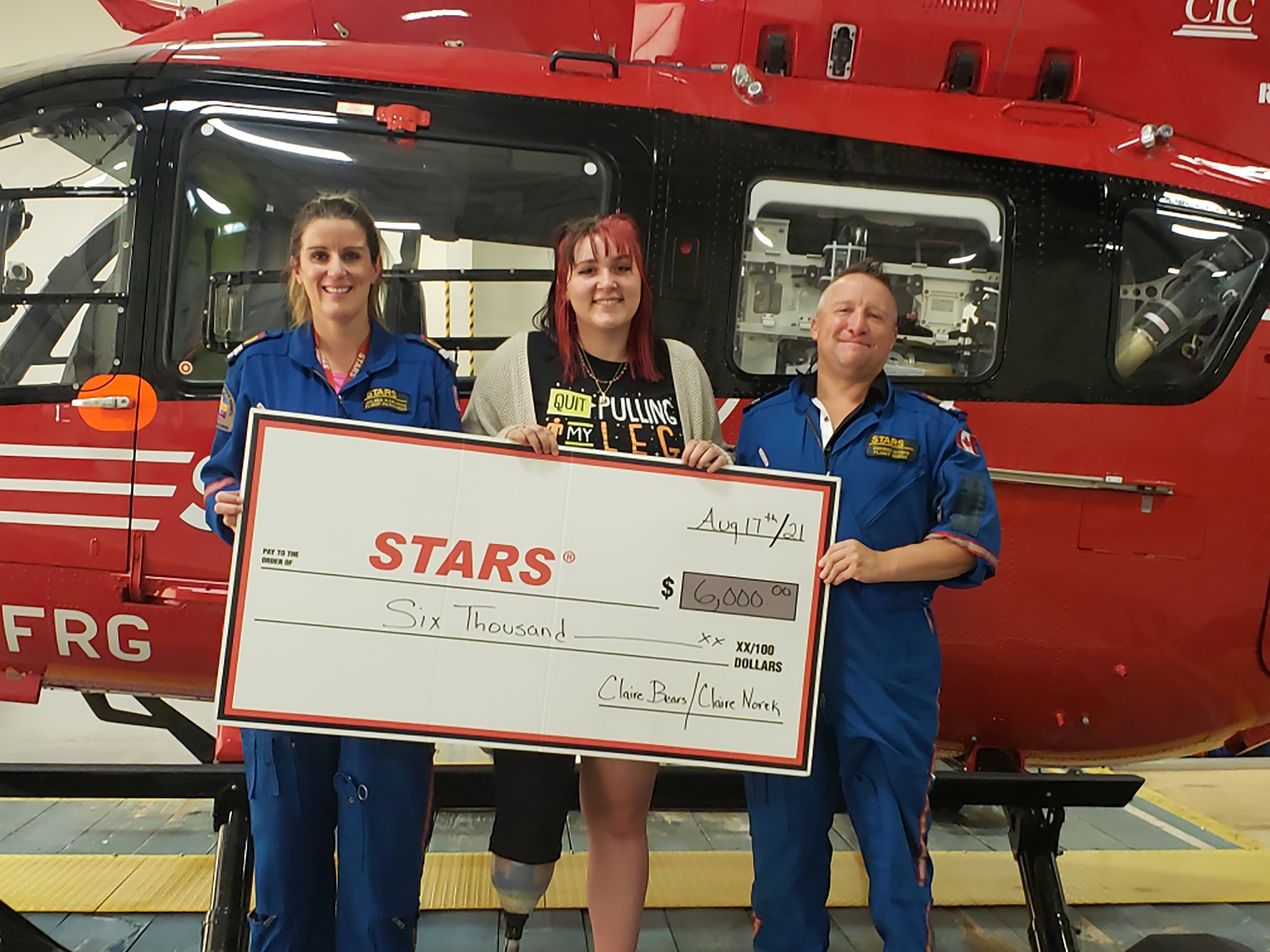 Claire present a cheque for $6,000 to Jolene Karapita and Darren Entner of STARS. The Claire Bear fundraiser raised $6,500 for the Norek family. They decided to pay it forward by donating the funds to STARS and the Esterhazy Fire Department.