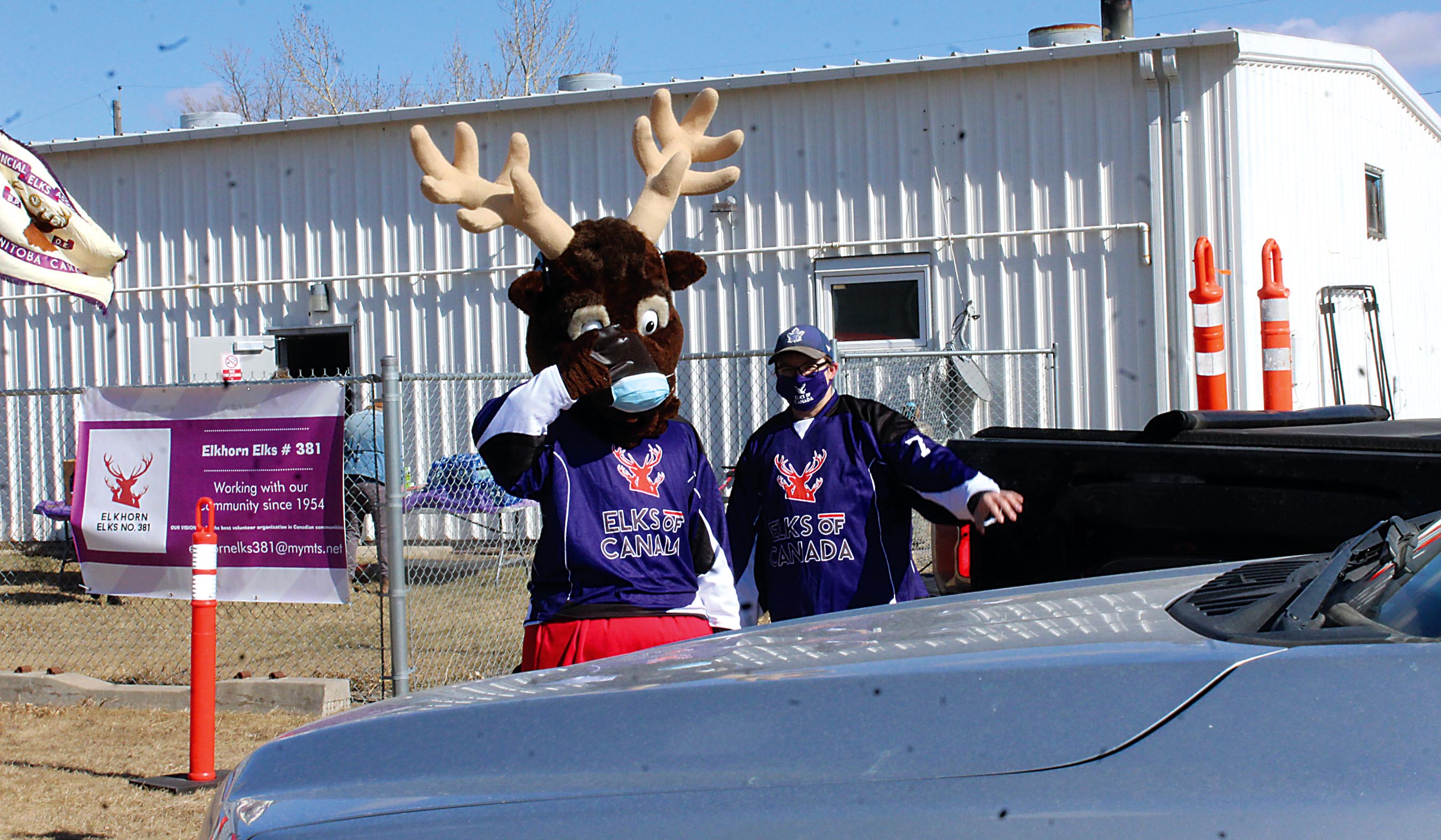 Elks Club mascot Charlie The Elk waving to people as they came by for the lunch.