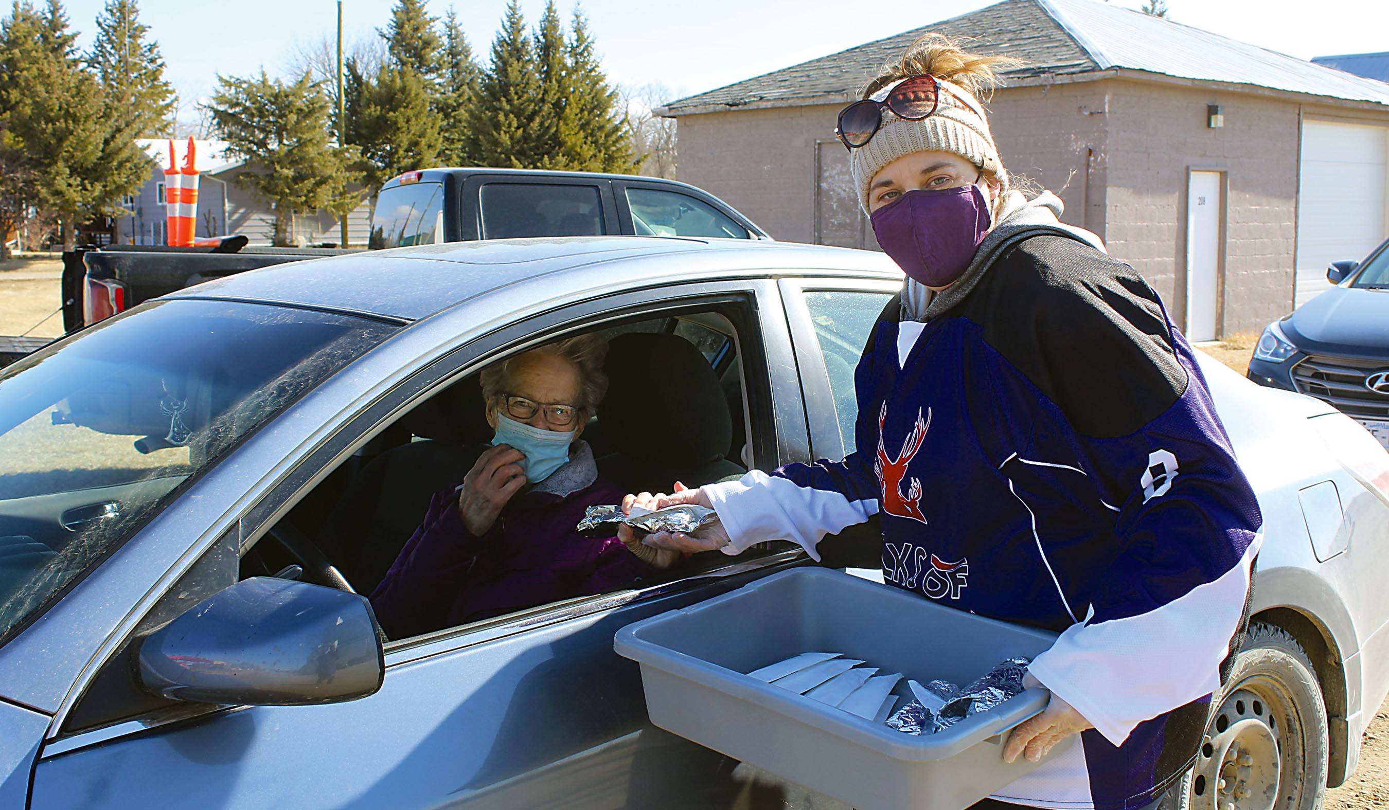 Volunteers with the Elks handing out free hot dogs and drinks to the line of cars as they came by.