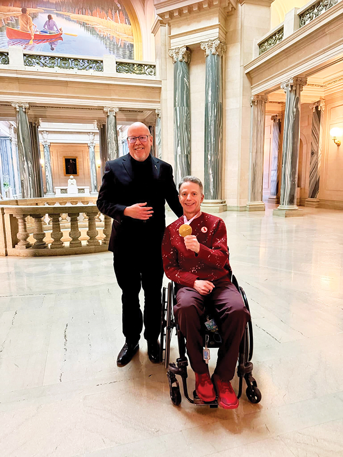 Gil Dash with Moosomin-Montmartre MLA Kevin Weedmark at the Legislature after winning gold.