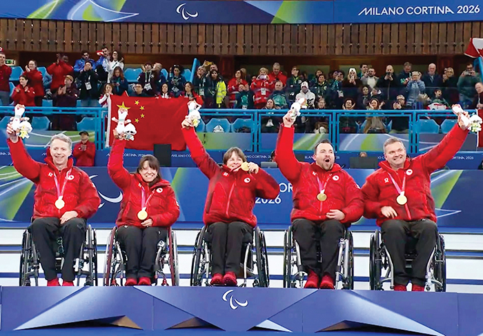 Gil and his teammates at the Olympics with their gold medals.