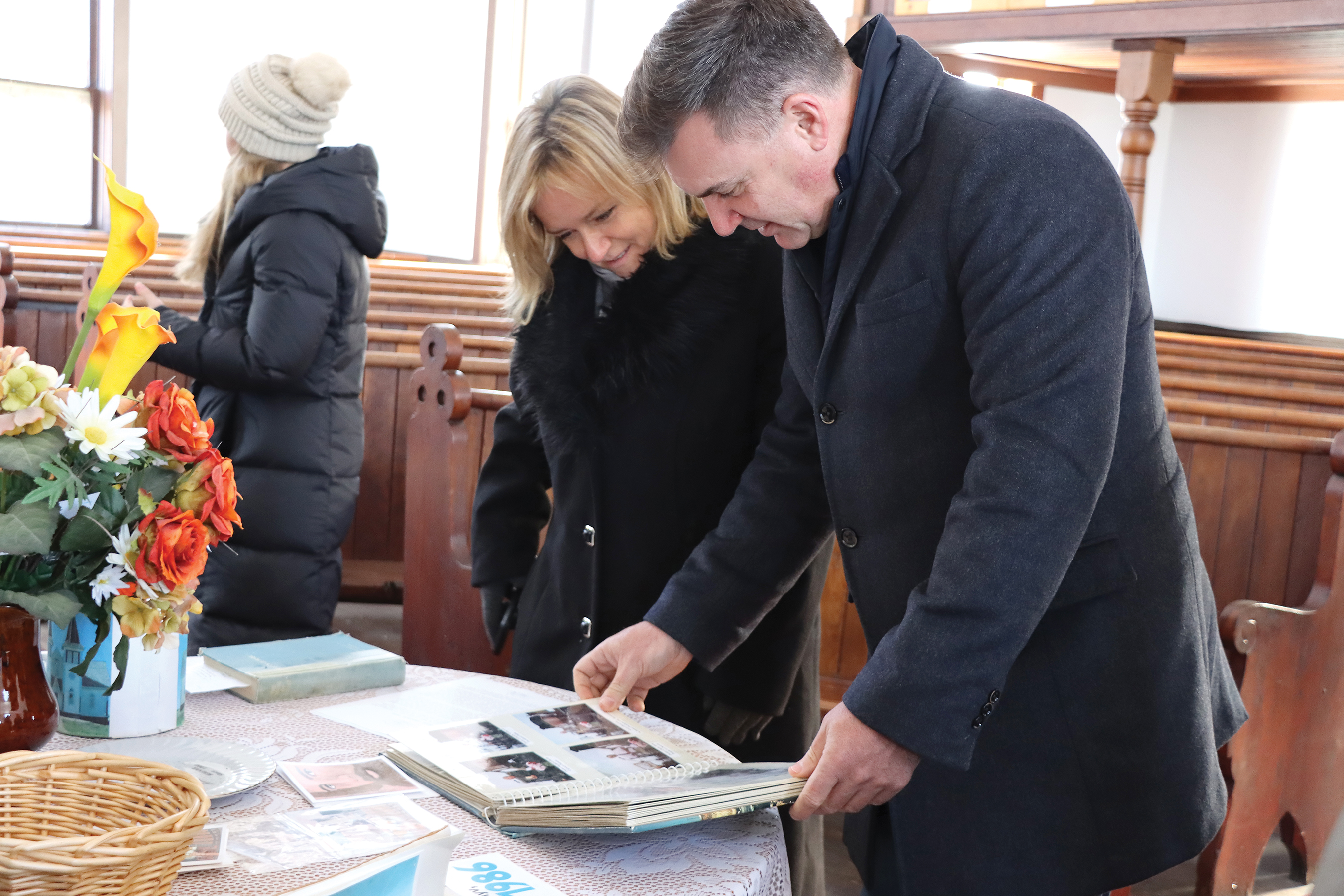 Ambassador of Hungary Maria Vass-Salazar and Moosomin MLA Steven Bonk looking at historical photos in Bekevar church.<br />
