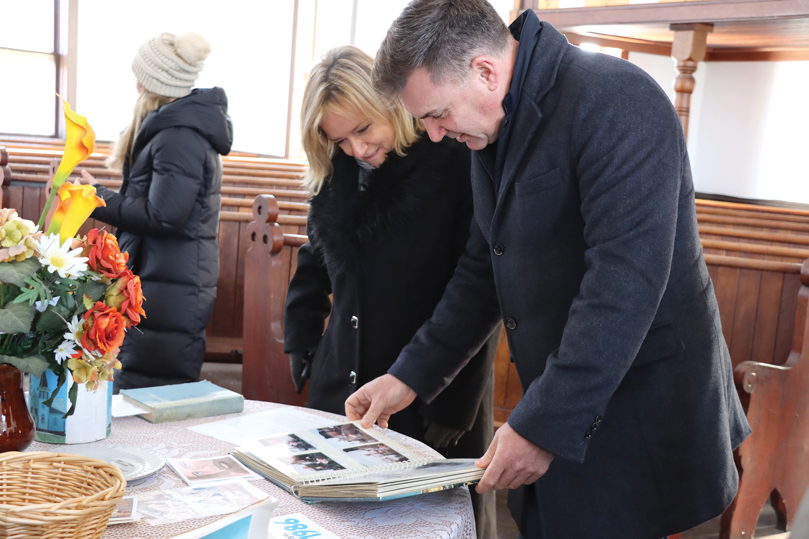 Ambassador of Hungary Maria Vass-Salazar and Moosomin MLA Steven Bonk looking at historical photos in Bekevar church.<br />
