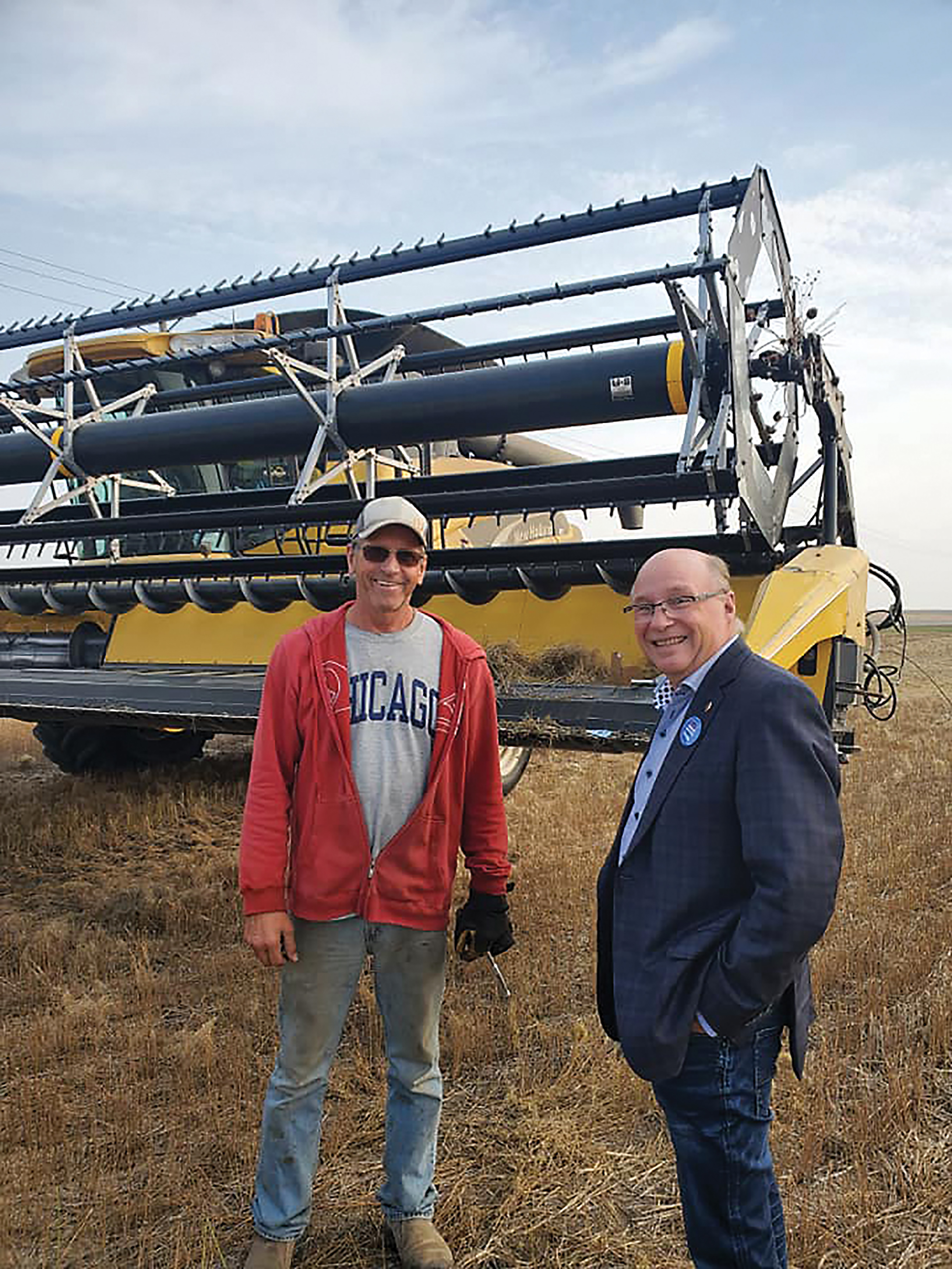 Dr. Robert Kitchen in a field with a farmer.