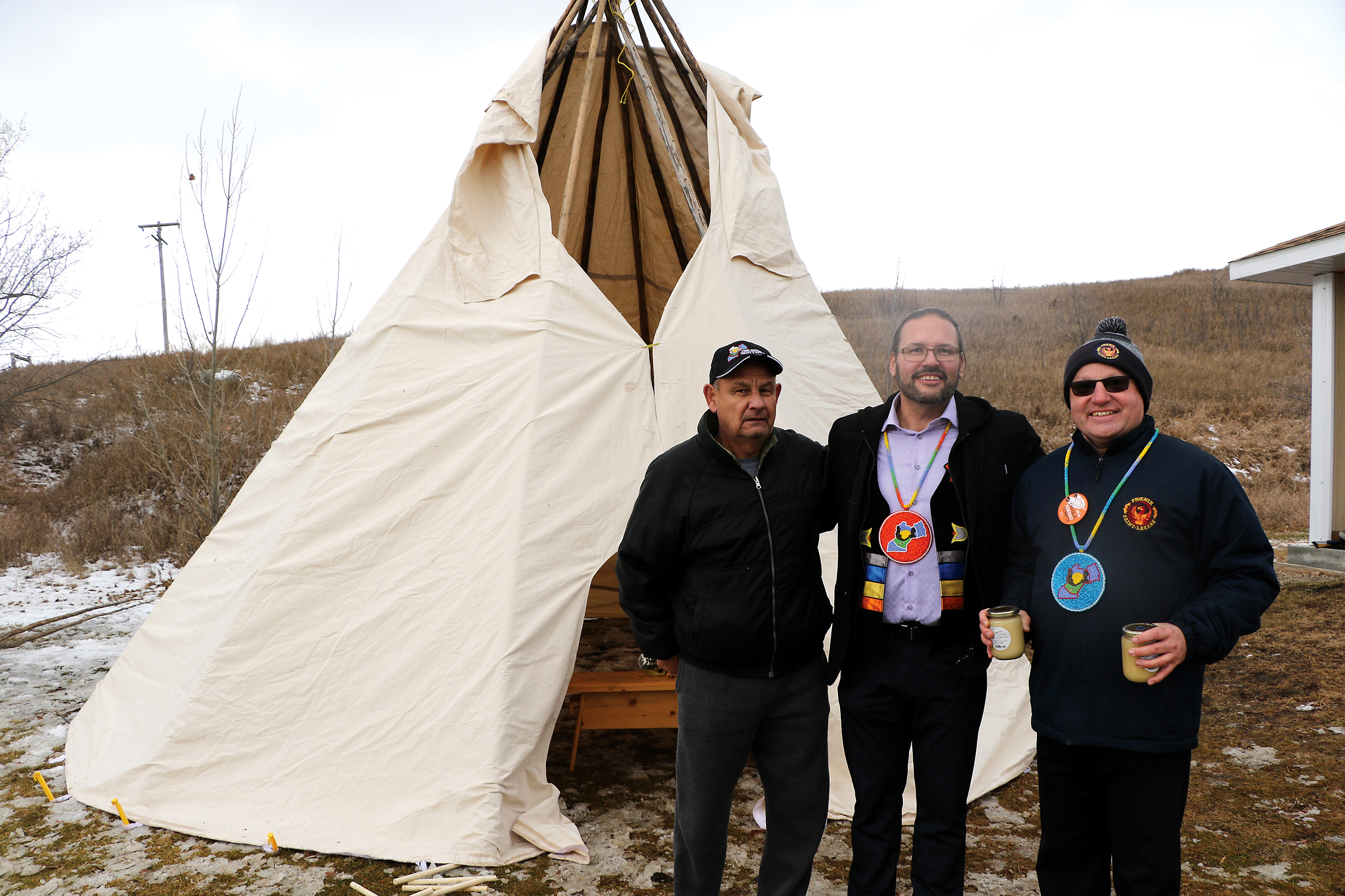 Terry Haney, president of the local MMF Fort-Ellice, Boh Kubrovich Lead Keeper and Richard Fiola, principal of cole Saint-Lazare, stand by the finished tipi on Tuesday.