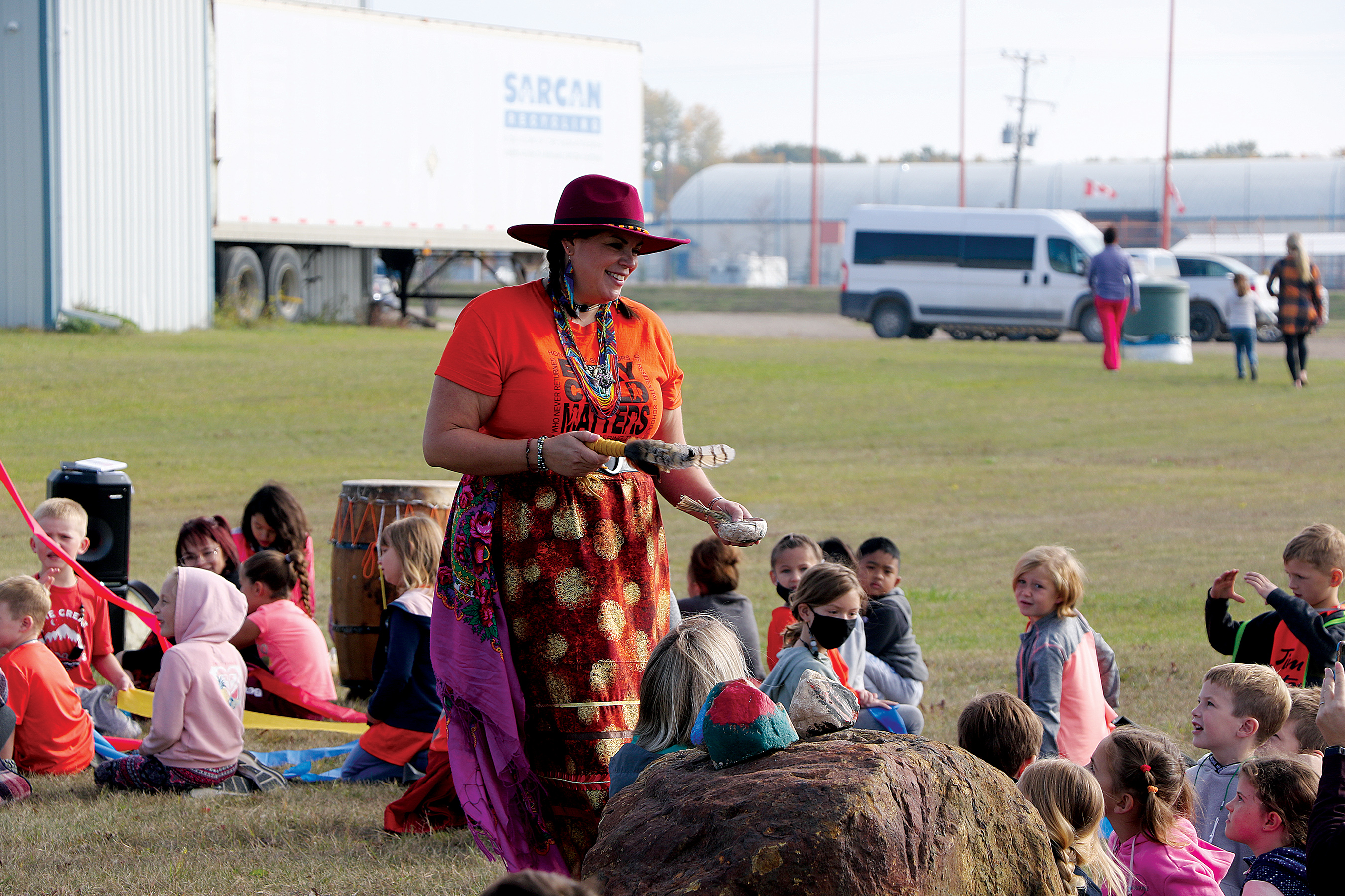 Joy Flaman smudging the students during the ceremony.