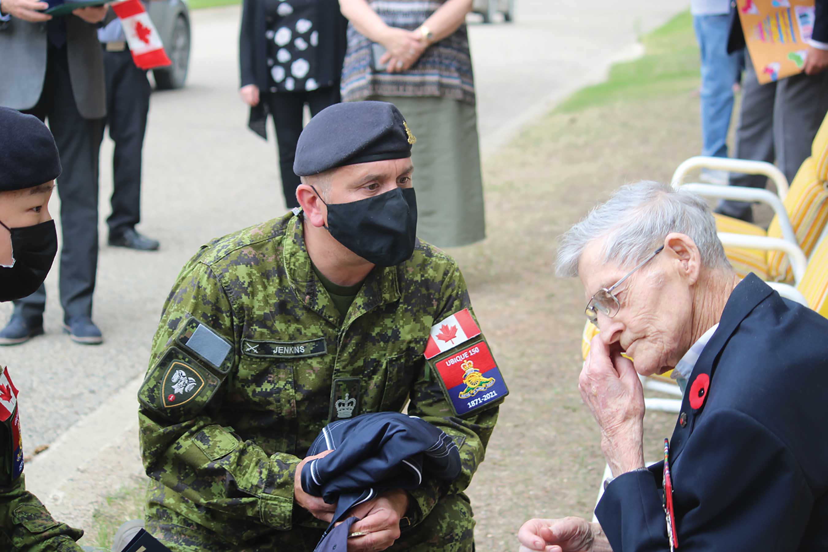 Captain James Lee and Warrant Officer Mike Jenkins of 1st RCHA, CFB Shilo, sharing a personal moment with Les as they talked about D-Day and the Second World War. Les is seen wiping away a tear.