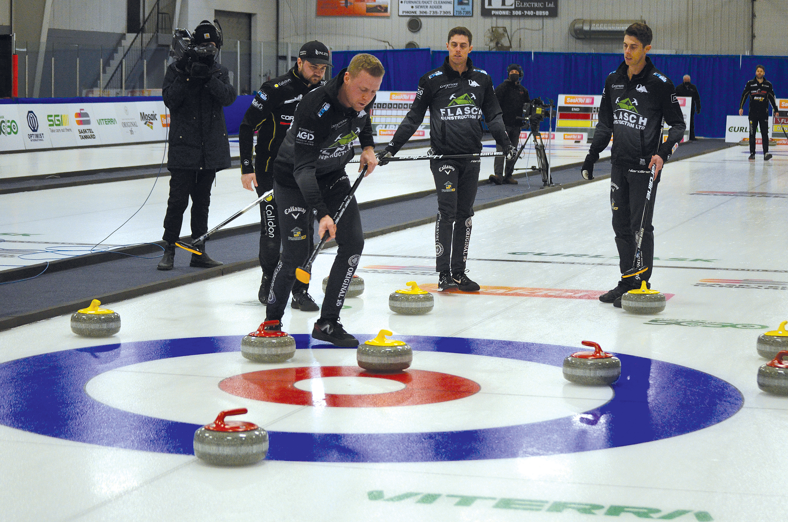 Coach Colton Flasch is ready to sweep his opponent�s rock as it rolls into the ring during the playoff game at the Tankard in Whitewood on Feb. 13. Skip Matt Dunstone (behind Flasch) and Kevin Marsh and Daniel Marsh of Team Flasch look on. Flasch went on to win the game 6-4 over Matt Dunstone�s rink. 