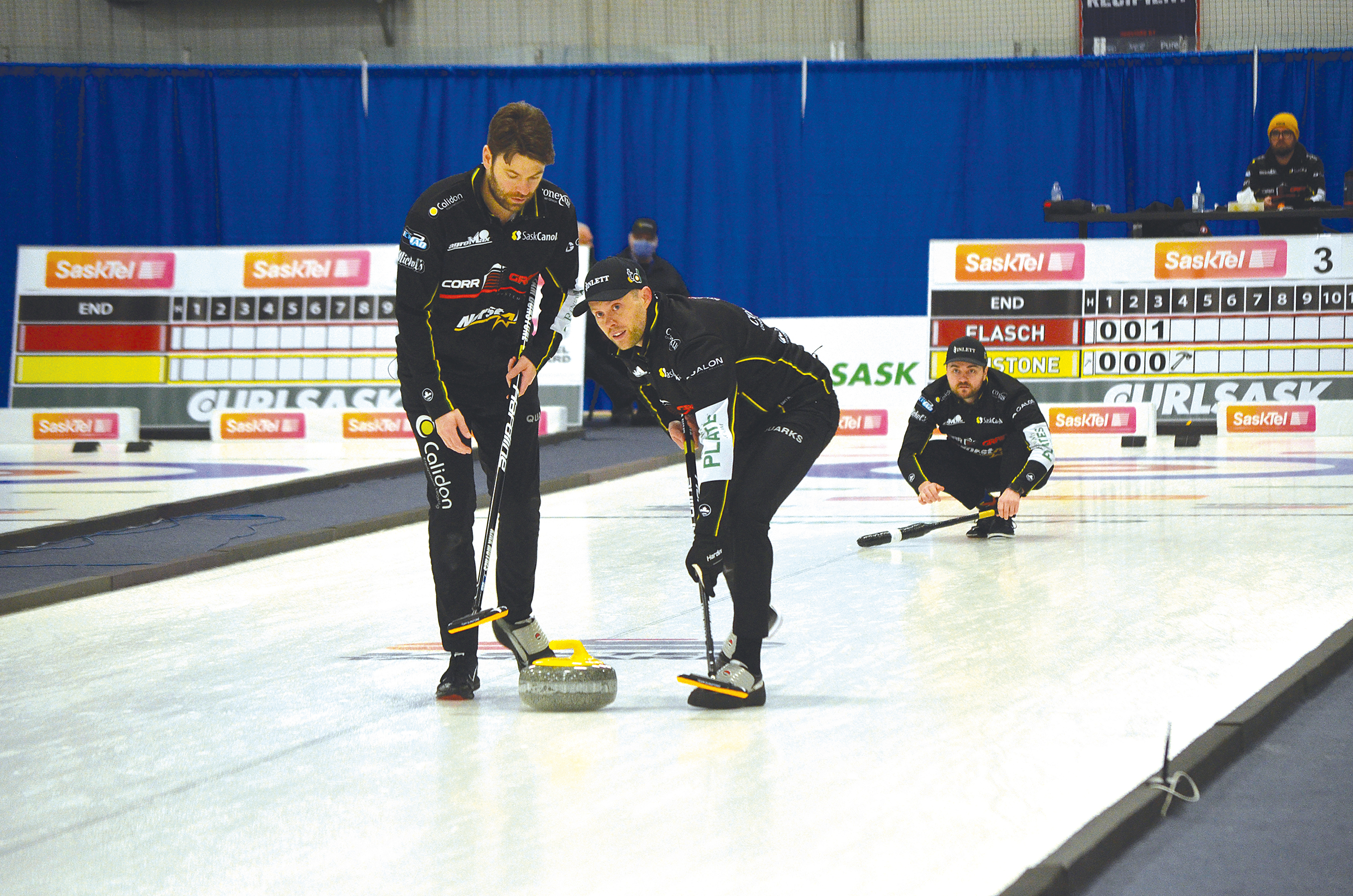 Skip Matt Dunstone�s rock is swept by his second, Kirk Muyres, left, and his lead player, Dustin Kidby early in the final game played against the Colton Flasch team in Whitewood during the Feb. 9-13 SaskTel Tankard. Dunstone�s team lost to Flasch when Dunstone�s final rock failed to net him what he needed to lead his team to victory.