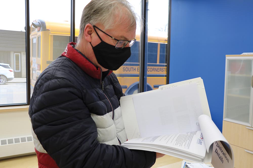 Moosomin recreation director Mike Schwean looks over the 150 page application he prepared for the Jays Care Foundation.