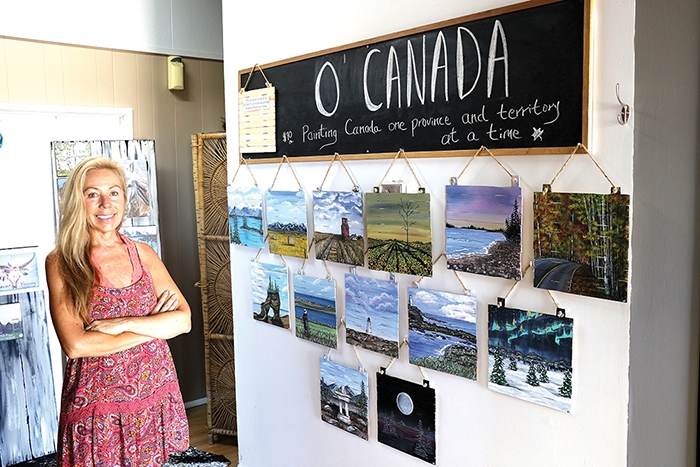 Eli Barsi standing next to her tribute to the provinces and territories for Canada Day.