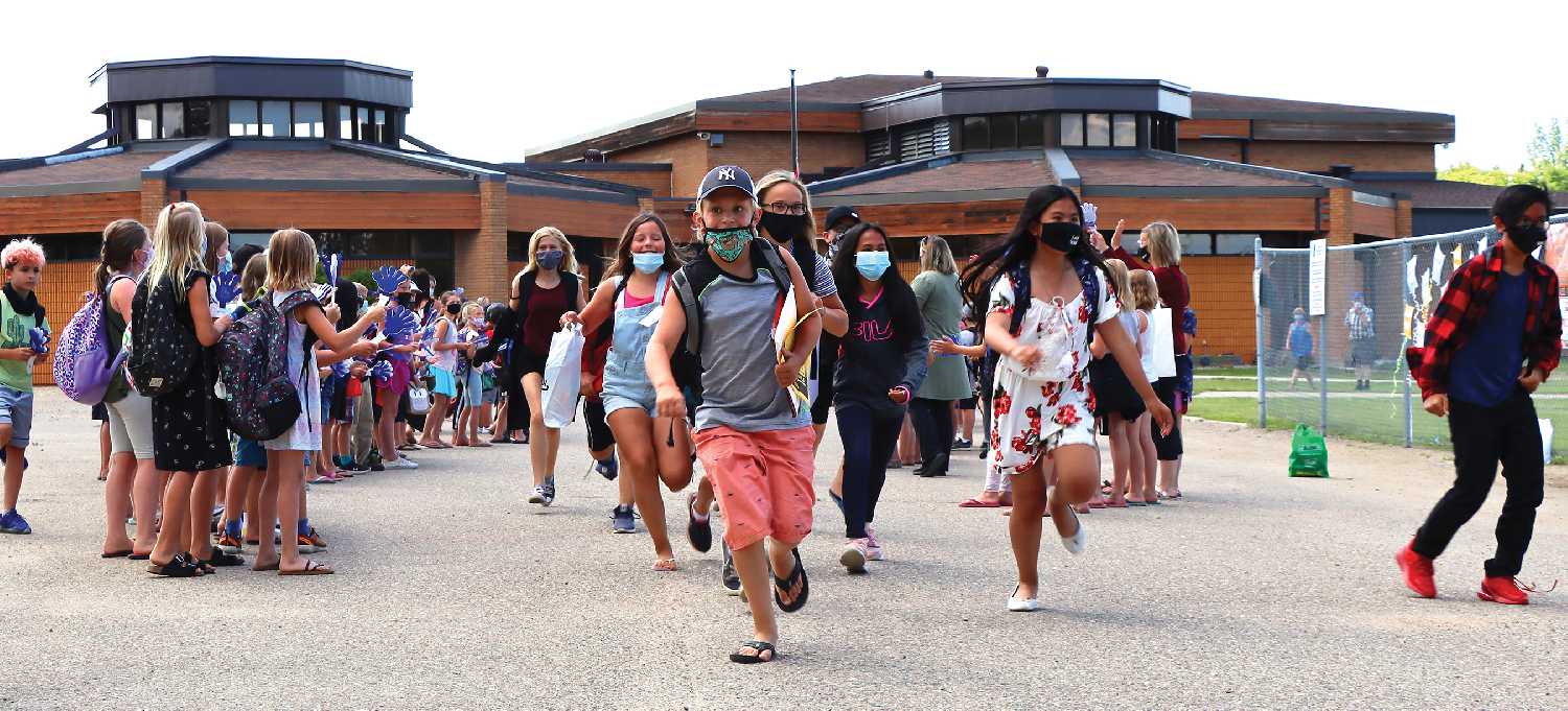 Grade 5 students leaving MacLeod Elementary School on the last day of school in the spring or 2021. In Southeast Cornerstone School Division, masks are still going to be required for students Grade 6 and younger when students are mixing with other cohorts outside their classroom.