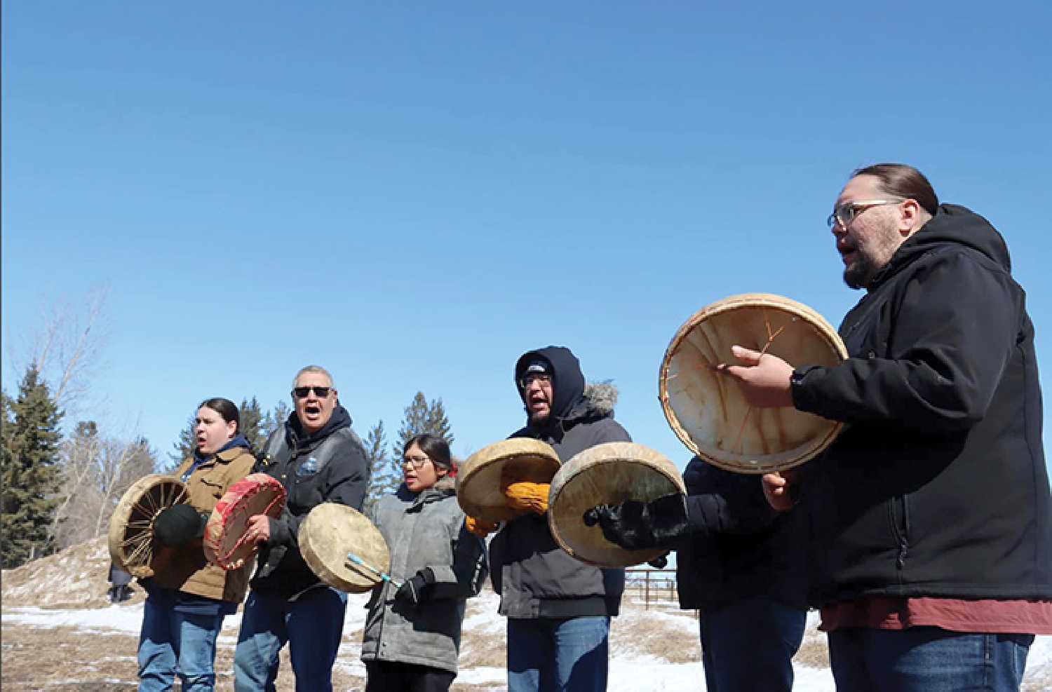 Members of Kahkewistahaw First Nation drumming during the welcome ceremony for the bison.