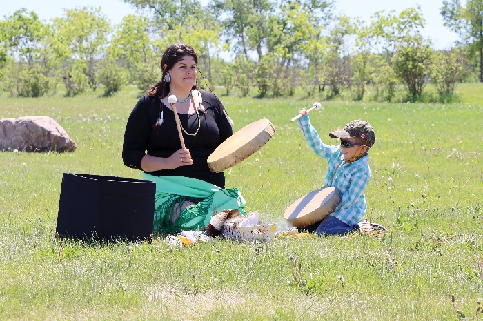 Joy Flaman drums with her son Hunter during the opening of the labyrinth last Saturday