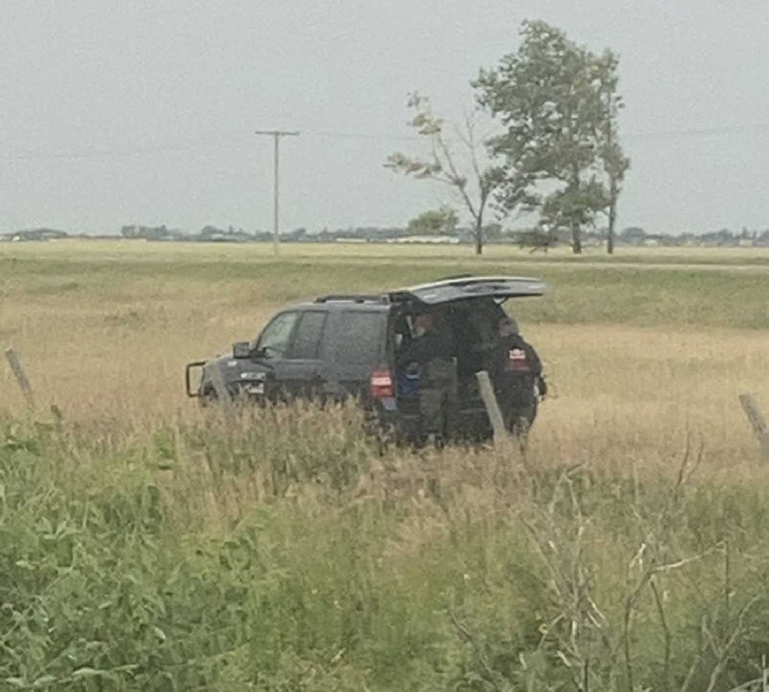 Federal officials taking water samples on Levi Wood's farm on August 19