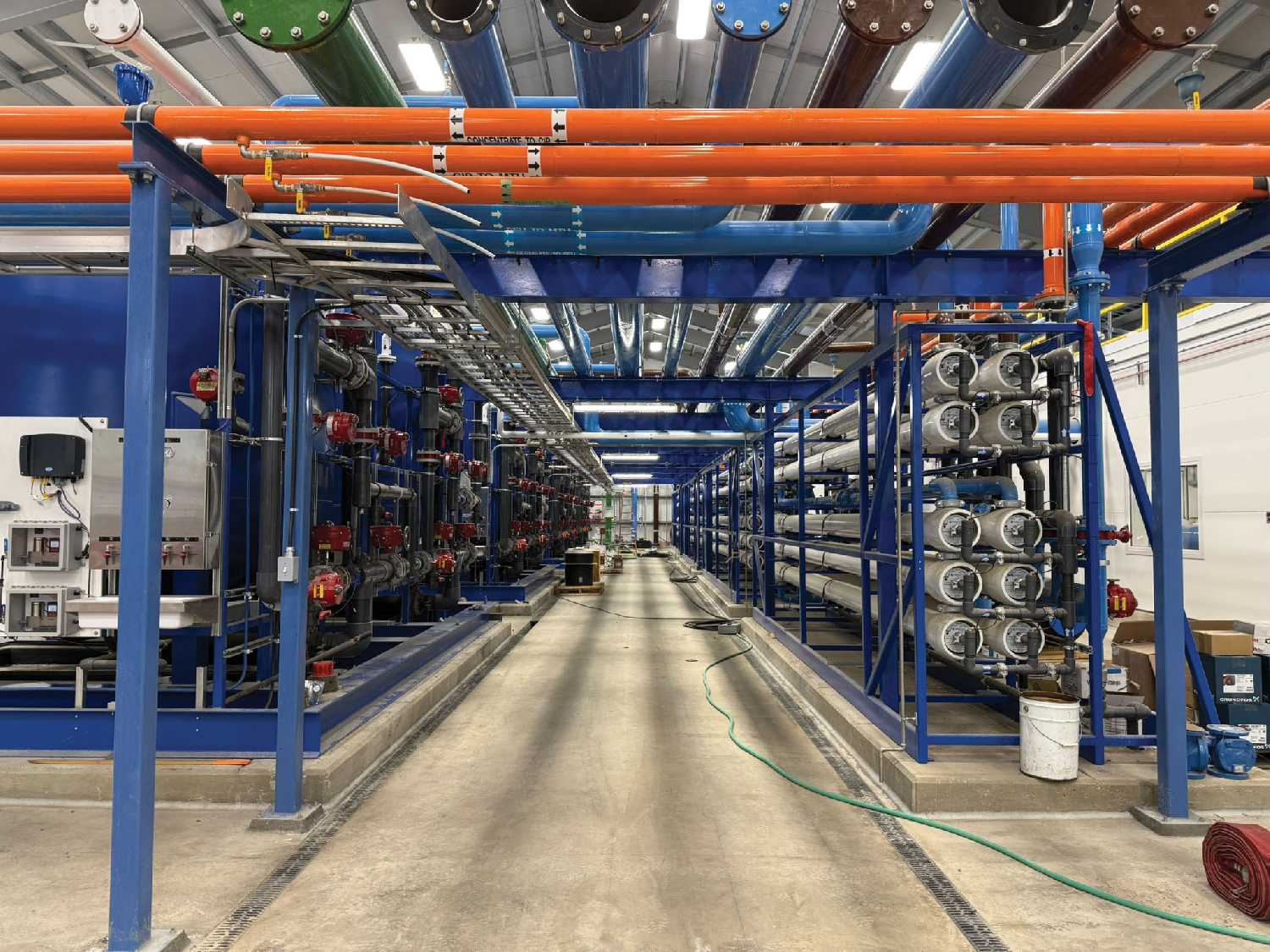 The process area. The pre-treatment system consists of four biological filtration skids with room for future expansion of two additional skids (left side of photo). This is followed by four membrane treatment skid, better known as reverse osmosis (RO) with room for future expansion of two additional skids (right side of photo). Delco Water and Suer plu Pollon Mechanical contributed to this component of the project.