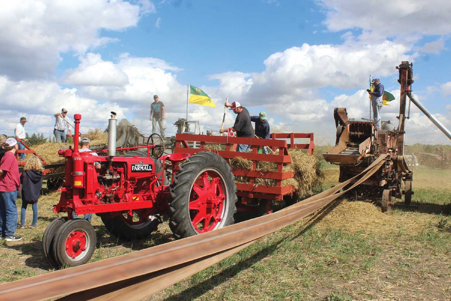 The threshing underway with lots of volunteers to pitch sheaves and run the equipment.