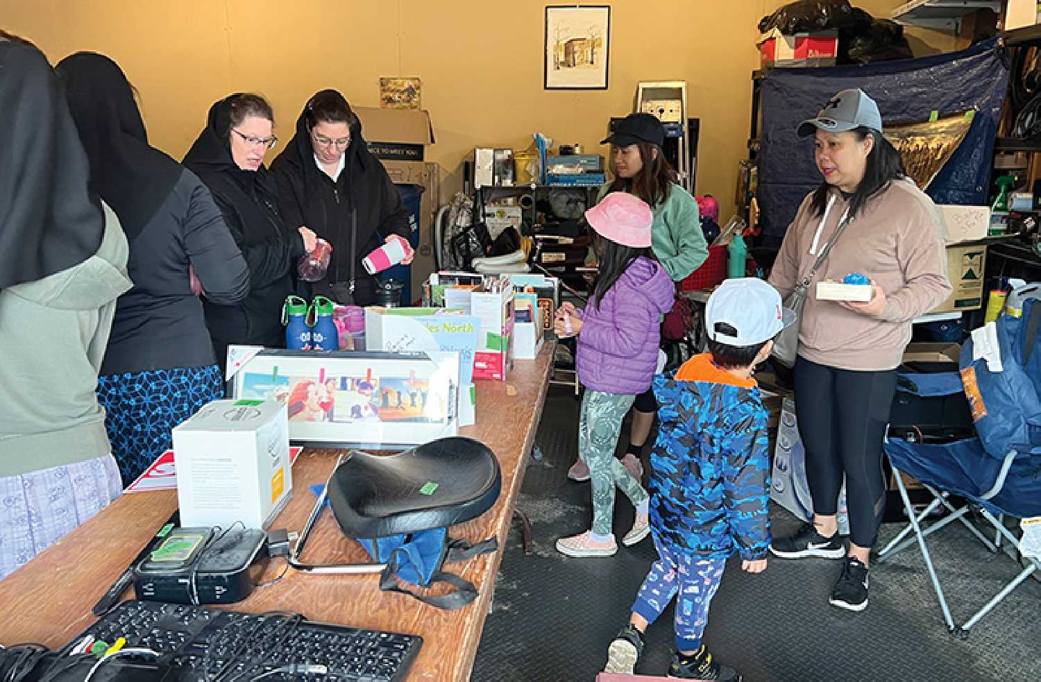 People taking in the deals at the town-wide garage sale in 2023. This year there are lots of other activities planned for the same day.