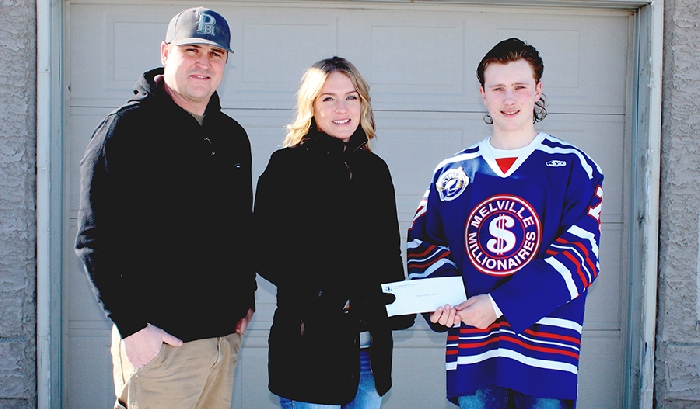 Kyle Bochek (right) of the SJHLs Melville Millionaires presents Michelle (centre) and Owen Wushke (left) a cheque for $14,300 after they won the teams Progressive 50/50 raffle.