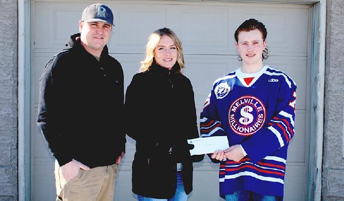 Kyle Bochek (right) of the SJHL’s Melville Millionaires presents Michelle (centre) and Owen Wushke (left) a cheque for $14,300 after they won the teams Progressive 50/50 raffle.