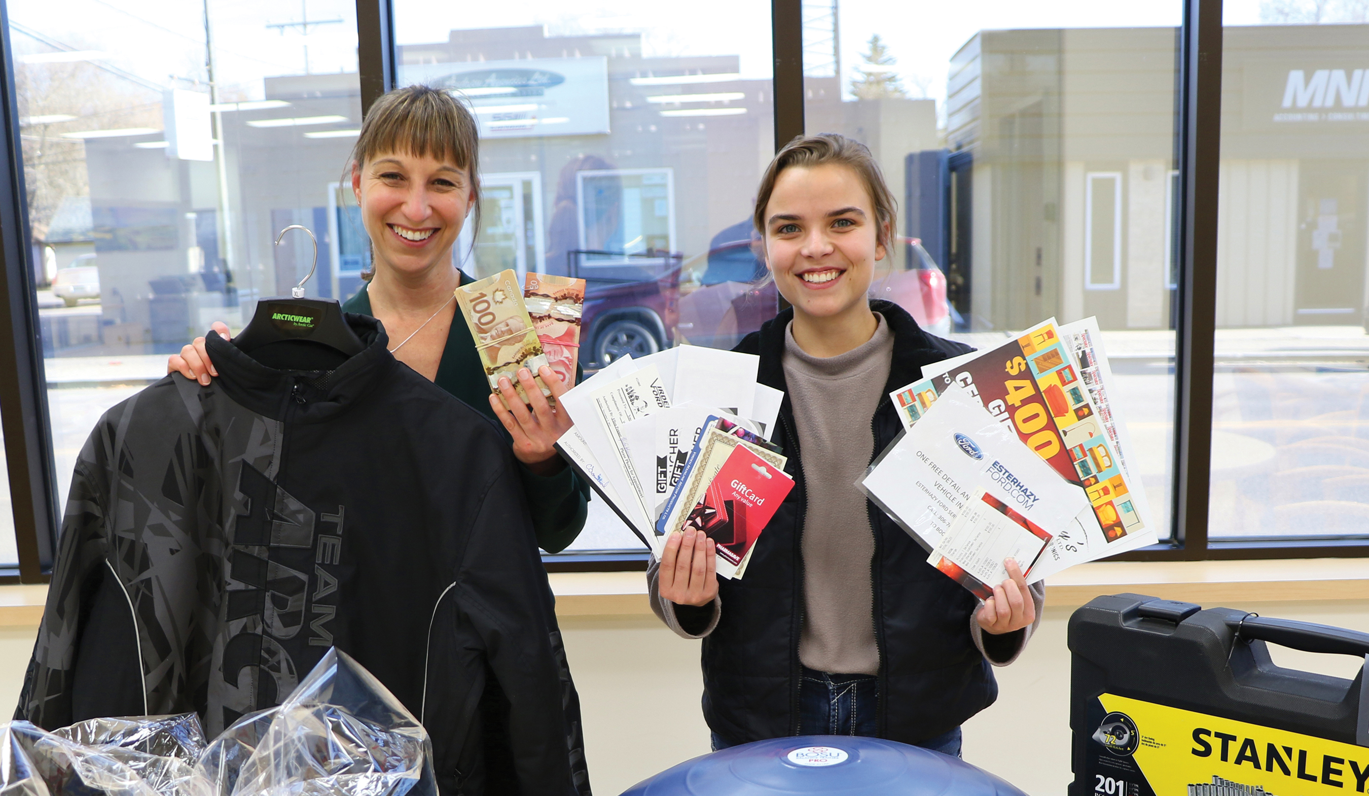The World-Spectator’s Kara Kinna and Sunnette Kamffer with some of the prizes in the World-Spectator’s $15,000 Christmas Giveaway