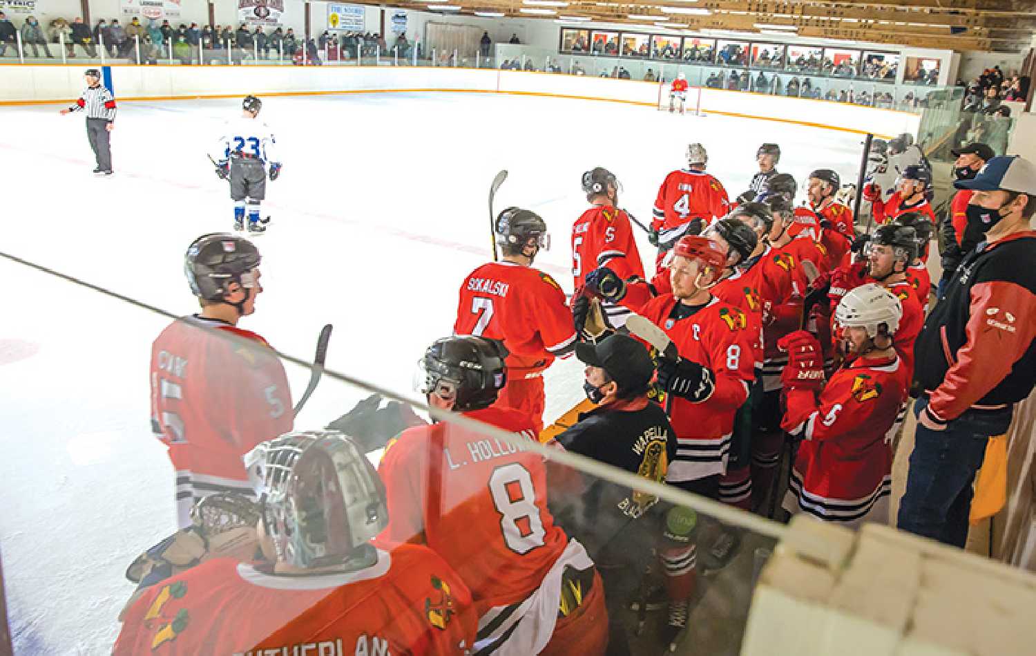 Moosomin Rangers players with Wapella Blackhawks jerseys during a game held at the Wapella rink last winter to honor the Wapella Blackhawks. Many of the Blackhawks alumni players were on hand at the game, some of them watching young relatives or immediate family members on the ice that night. Kim Poole photo.