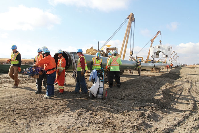 Construction on Line 3 Workers on the Enbridge right-of-way Wednesday. In the background are welding shacks that are picked up and moved to each connection between two joints of pipe. Editor Kevin Weedmark spent the day on the line Wednesday.