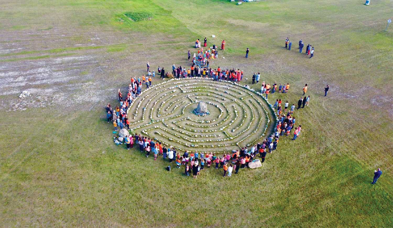 The students surrounding the labyrinth at the start of the ceremony