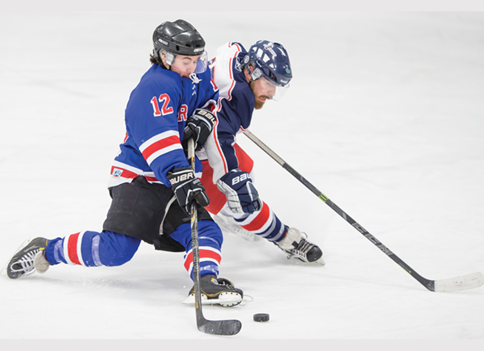 The Moosomin Rangers Tucker McMullen battles for the puck with one of the Virden Oil Kings in a game played in Moosomin on Sunday, Feb. 14. The Rangers defeated Virden 9-1.